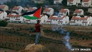 Palestinian protester opposite Jewish settlement of Halamish in the West Bank. Oct 2010