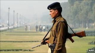 An Indian security official on guard in Delhi on 8 December 2010; Indian cities are on high alert after Tuesday's blast in Varanasi