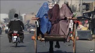 Afghan women travel on horse-drawn cart in Kandahar city, south of Kabul, Afghanistan, Tuesday, Nov 23, 2010.