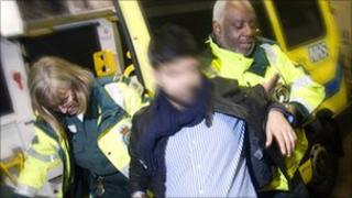 A man is treated by London Ambulance staff