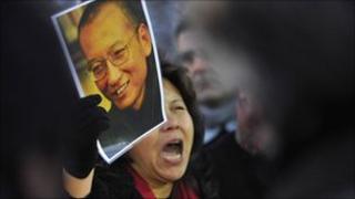 A protester holds an image of jailed dissident Liu Xiaobo outside of the Chinese Embassy in Oslo December 9, 2010