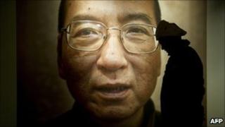 A man passes a poster of jailed Chinese dissident Liu Xiaobo in Oslo, 9 December