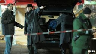 Funeral service employees at the scene of the shoot-out