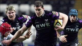 Ospreys' Ian Evans hands off Edinburgh's Kyle Traynor during a recent match at the Liberty Stadium