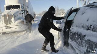 A Sarnia police officer checks on a stranded motorist