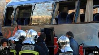 Croatian firefighters and others survey the damaged coach, 14 December