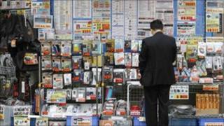 A man outside a Tokyo electronics shop