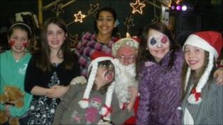Children with Santa at party