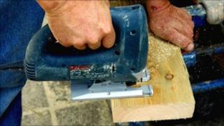 Worker using a jigsaw saw