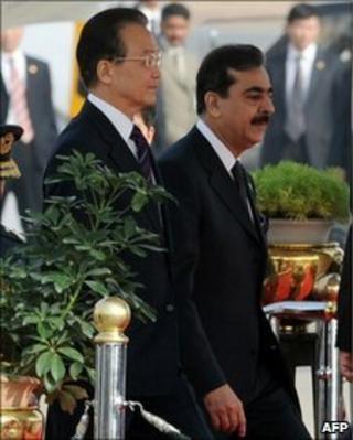 Chinese Premier Wen Jiabao (L) walks with Pakistani Prime Minister Yousuf Raza Gilani at the Pakistani military Chaklala airbase in Rawalpindi on December 17, 2010.