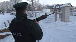 A police officer guards the house which was targeted in the grenade attack