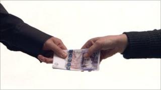 Sterling notes being handed over