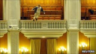 Protestor Adrian Sobaru jumps from a balcony in the Romanian parliament