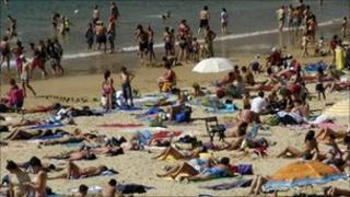 Sunbathers on a beach at San Sebastian in the Basque country, Spain
