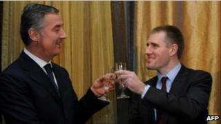 Igor Luksic (R) raises a glass with his predecessor and mentor Milo Djukanovic