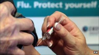 A flu jab being administered
