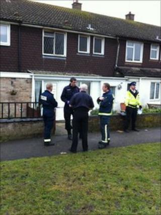 Fire officers and police outside the house