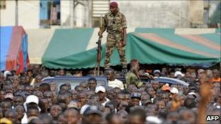 An Ivory Coast soldier stands guard during a pro-Gbagbo rally held by youth leader Charles Ble Goude