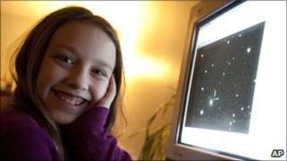 Kathryn Gray, 10, at home in Birdton, New Brunswick, Canada, on 3 Jan 2010, sits next to the computer monitor on which is the image in which she discovered the supernova