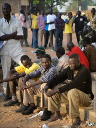 Southern Sudanese men queue outside the University of Juba polling centre