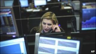 A Portuguese financial broker in Lisbon talks on the phone