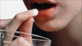woman taking a pill