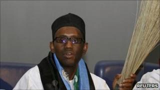 Nigeria's former anti-corruption chief Nuhu Ribadu holds a broom as he declares his presidential bid in the capital Abuja, 15 December 2010