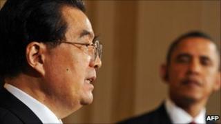 US President Barack Obama looks on as President Hu Jintao answers a question at the press conference in Washington on 19 Jan 2011