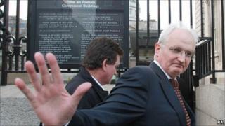 Green Party leader John Gormley outside government buildings in Dublin