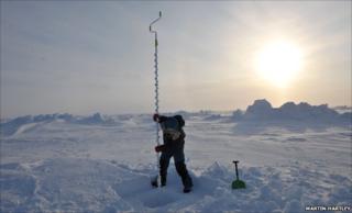 Drilling a hole in the ice