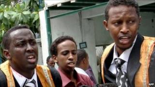 Somali university graduates help someone injured during the blast at the Shamo Hotel on 3 December 2009