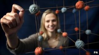 Student Isobel Marr, 23, with the molecular model of common salt, made from balls of wool and knitting needles