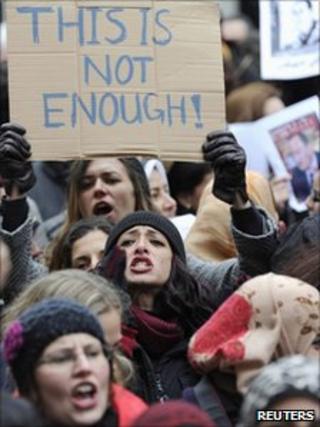 A demonstrator holds a placard during a protest at the Egyptian embassy in London
