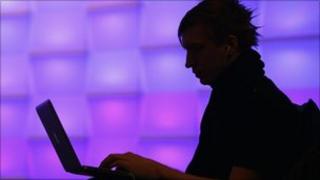 Silhouette of man with a laptop