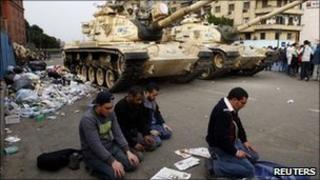 Men pray in front of tanks in Cairo's Tahrir Square - 1 February 2011