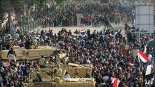 Anti-government demonstrators (top) face pro-regime opponents in Tahrir Square, 2 February