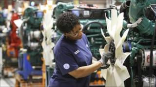 Production worker fits a fan on a truck engine at the Volvo plant in Dublin, Virginia, US
