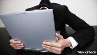 Man with head buried in laptop
