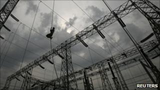 Electrician working on overhead cables