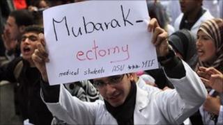 Egyptian medic holds an anti-Mubarak banner in Tahrir Square, 10 Feb 2011