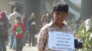 Boy with sign, Tahrir Square, Cairo (12 February 2011)