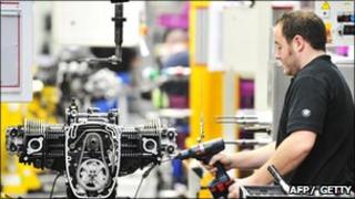 Worker assembles a motorbike