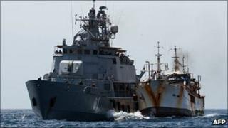 A picture taken on 10 February 2011 and released by the EU Navfor shows the EU Navfor warship FNS Pohjanmaa alongside fishing vessel Golden Wave
