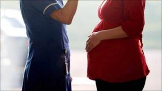 A midwife talking to a pregnant woman