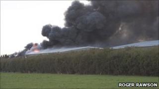 Smoke billowing from factory on fire