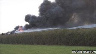 Smoke billowing from factory on fire