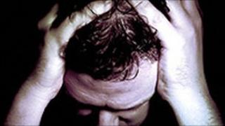 Man holding head in hands