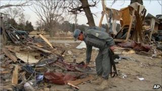 Afghan police man inspect the site of an explosion in Khost, south of Kabul, Afghanistan, Friday, Feb, 18, 2011