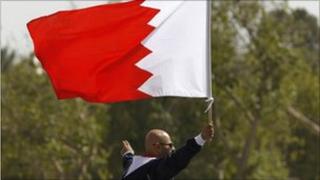 Man in Bahrain holds national flag during protests
