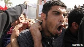 A mourner grieves at the funeral of a protester in Sitra, Bahrain, 18 February